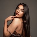 Striking studio portrait of an elegant brunette woman, showcasing grace and sophistication.